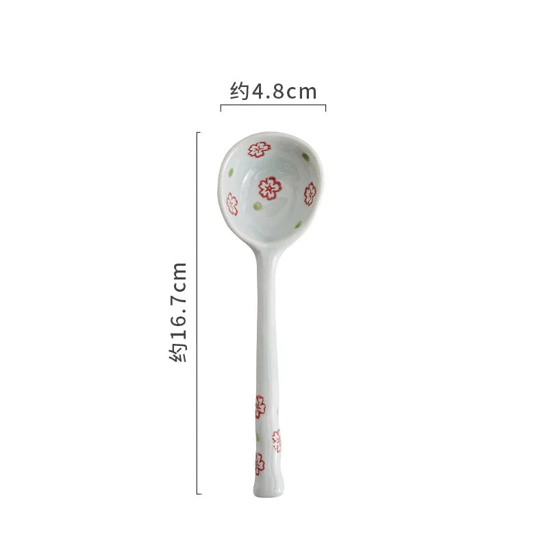 White ceramic kawaii spoon with floral patterns on a white background, showing measurements.