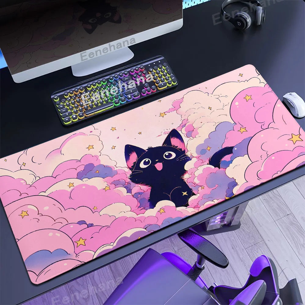 Desk setup with a pink and purple cloud-themed mouse pad featuring a Kawaii black cat design.