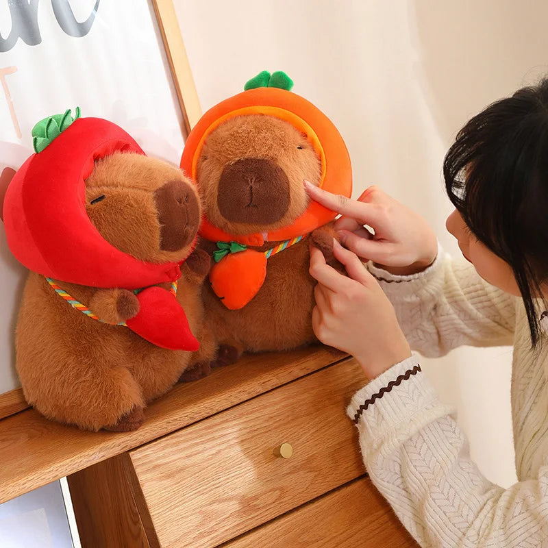 Two kawaii plush toys resembling bears with strawberry and carrot hats, being held by a person.