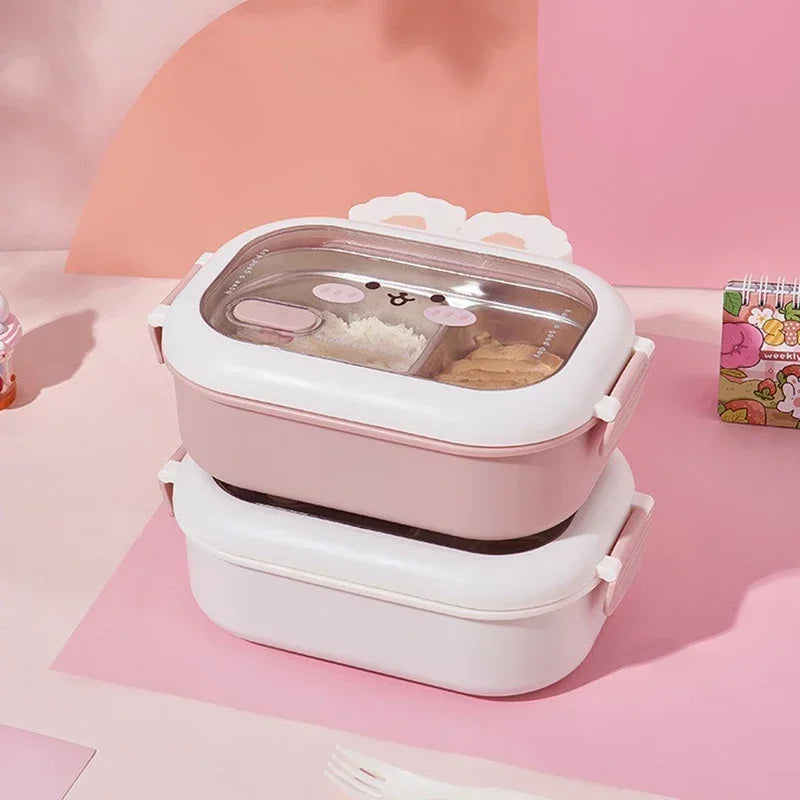 Pink and white kawaii lunch box with cartoon design on a pink background