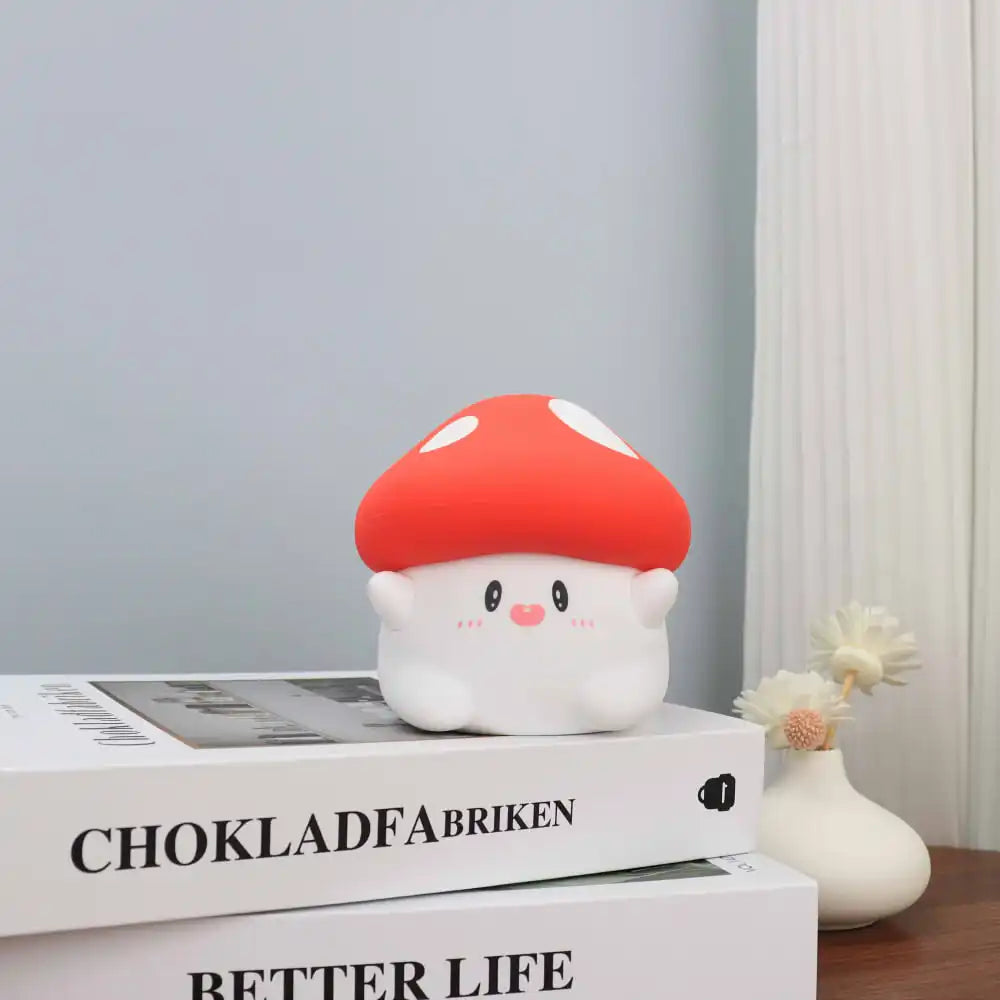 Cute mushroom-shaped kawaii lamp on books with a vase in the background