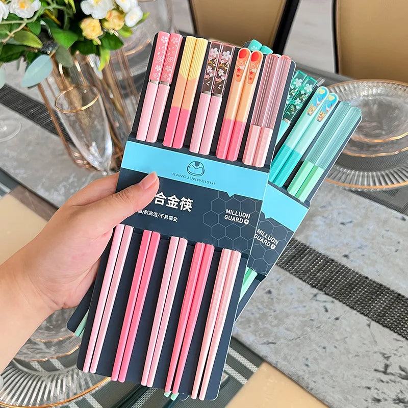 Set of colorful kawaii chopsticks in a packaging holder with a blurred background