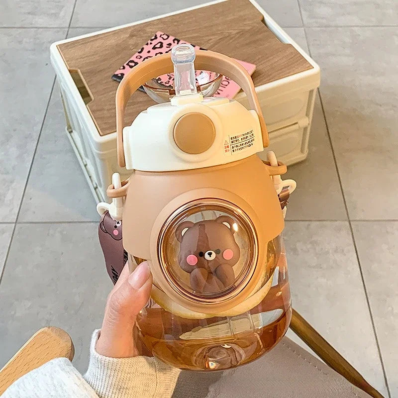 Cute bear-themed kawaii water bottle held by a person indoors.