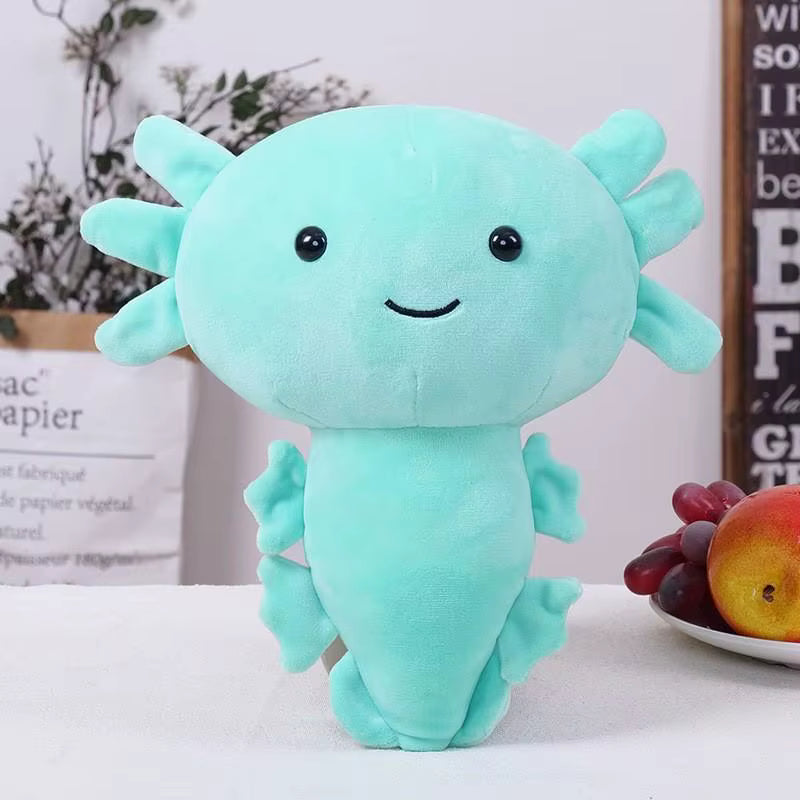 Turquoise axolotl plush toy on a white surface with a blurred background