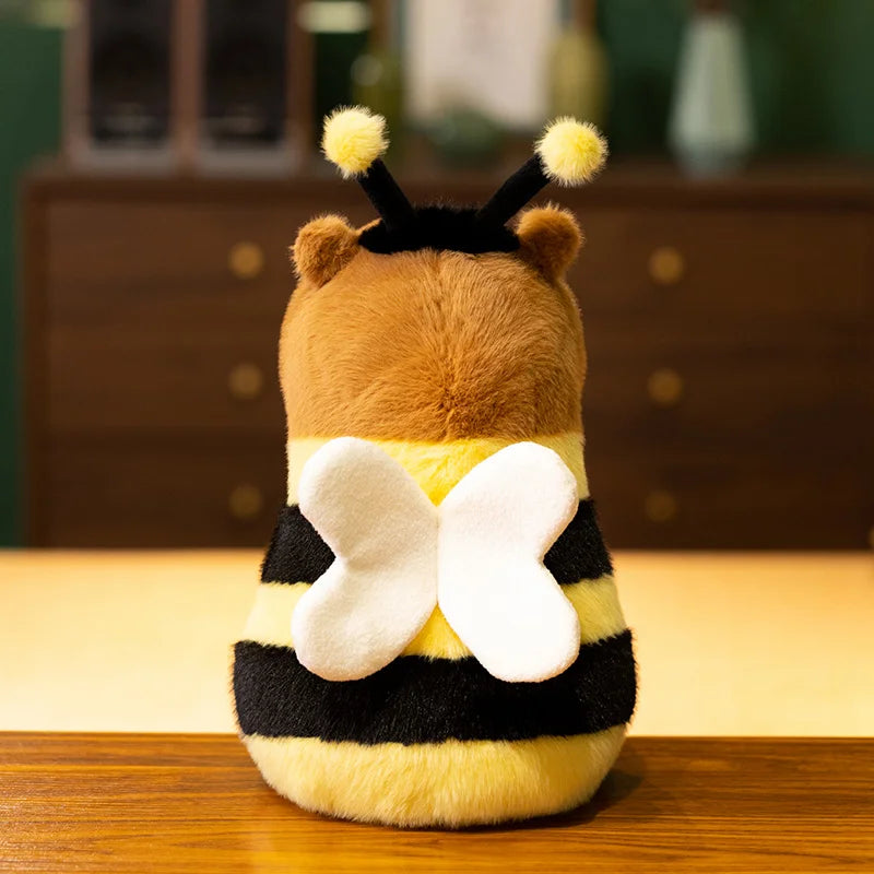 Kawaii plush toy shaped like a bee on a wooden surface with a blurred background
