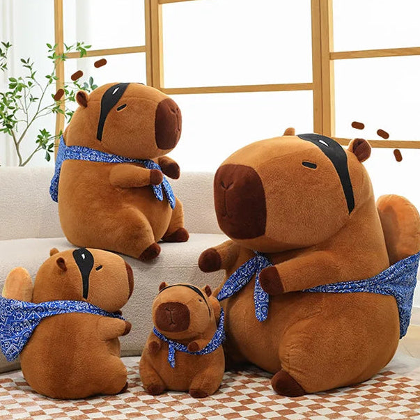 Set of brown kawaii plush bears with blue on a light-colored couch.