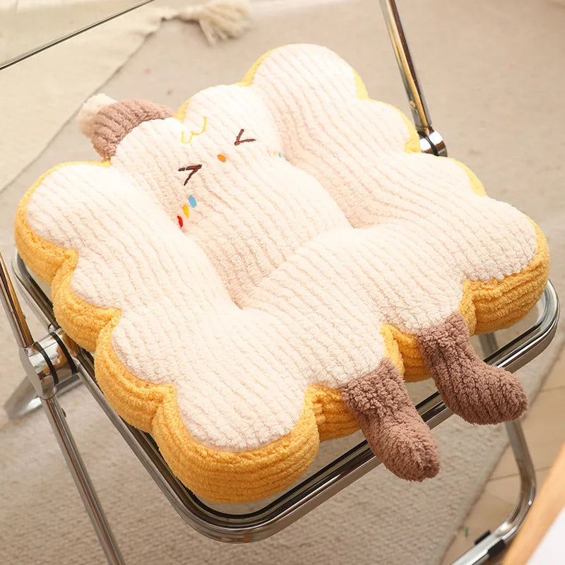 Plush cloud-shaped kawaii cushion with a smiley face on a chair