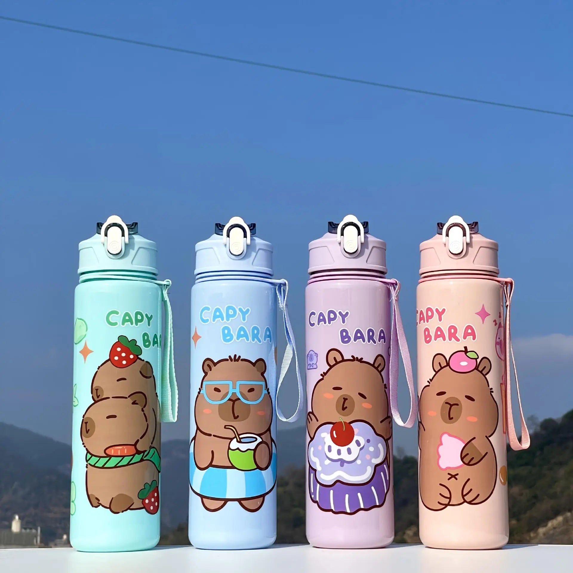 Four capybara -themed kawaii water bottles with characters on a blue sky background