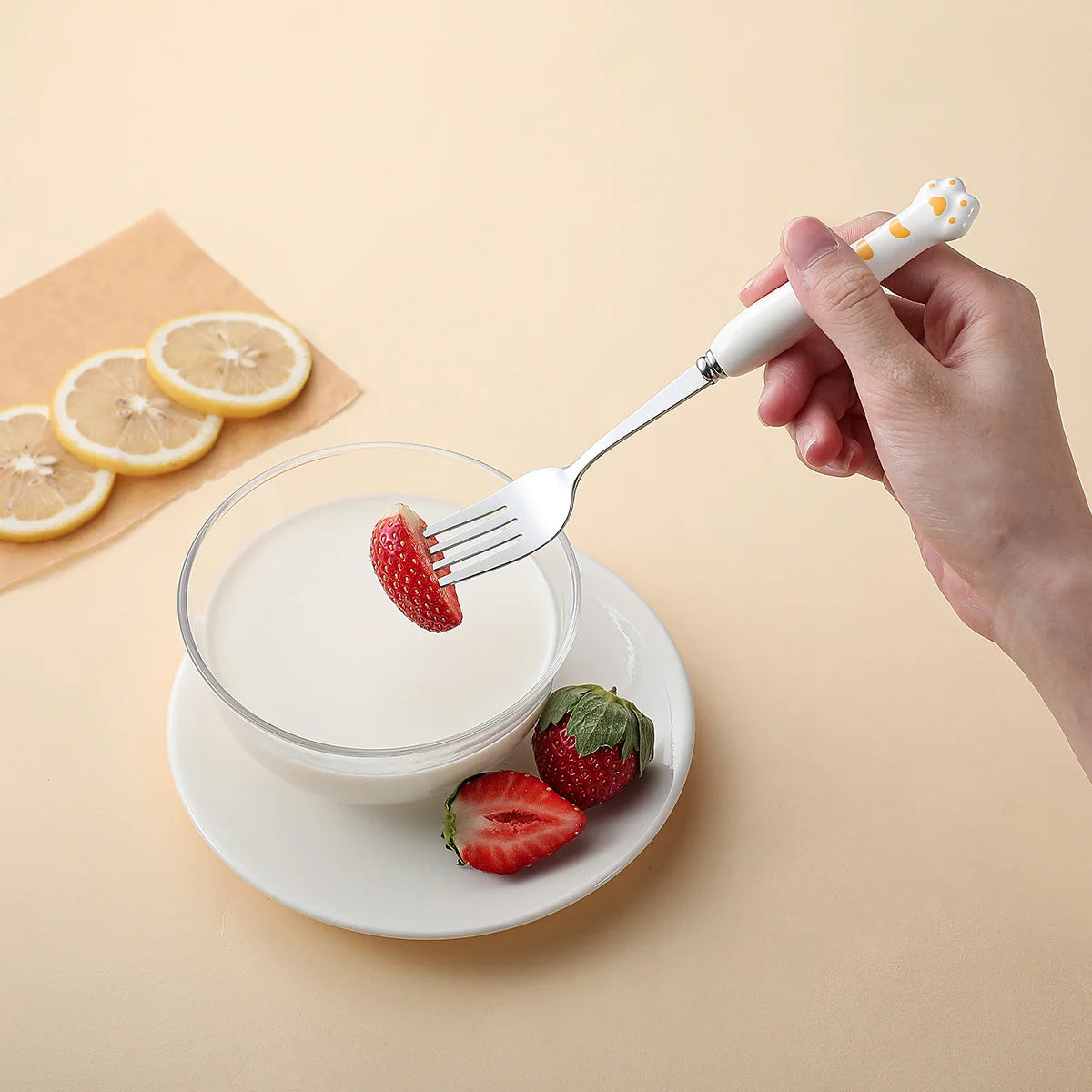 Someone eating a strawberry with a white kawaii utensil