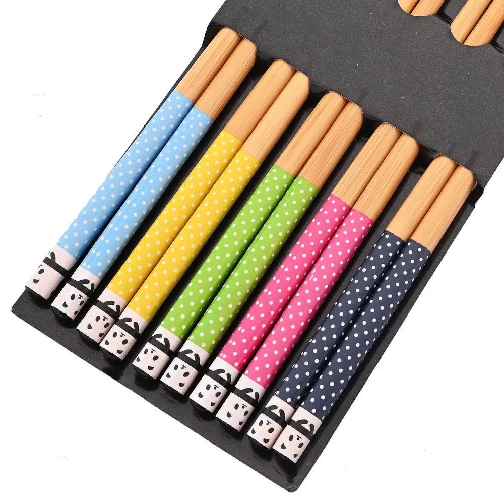 Set of colorful polka dot kawaii chopsticks with panda designs in a black case.