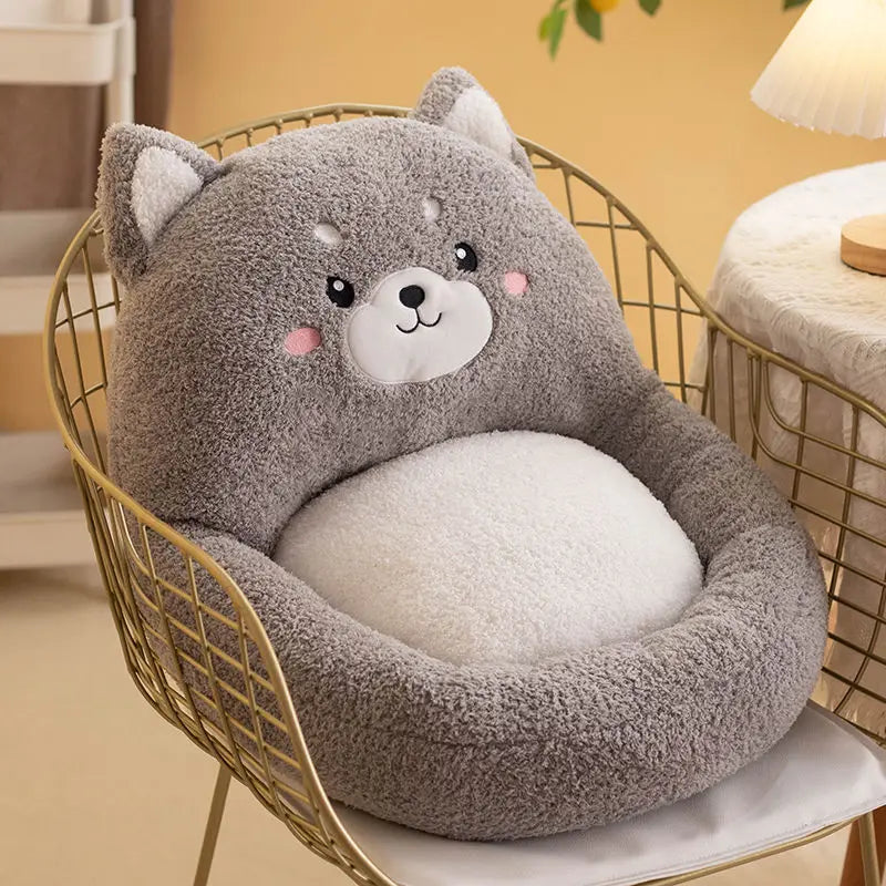 Cute gray bear-shaped kawaii cushion on a chair in a cozy room.