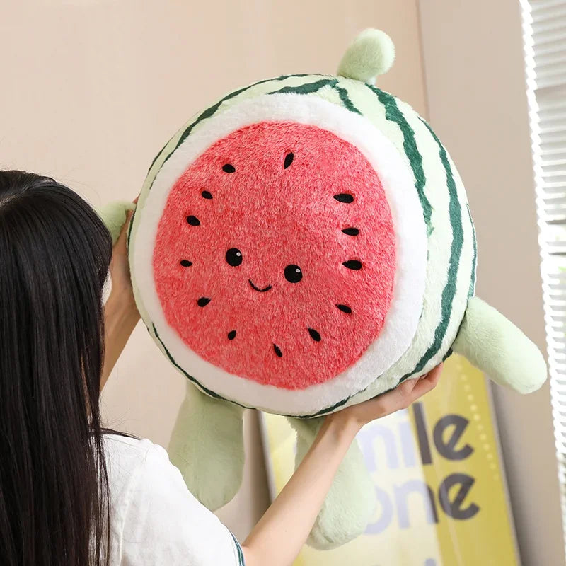 Person holding a kawaii plush watermelon toy against a neutral background