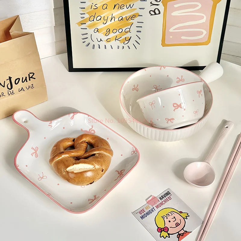 A set of ceramic kawaii ramen bowl and server with pink and white bows