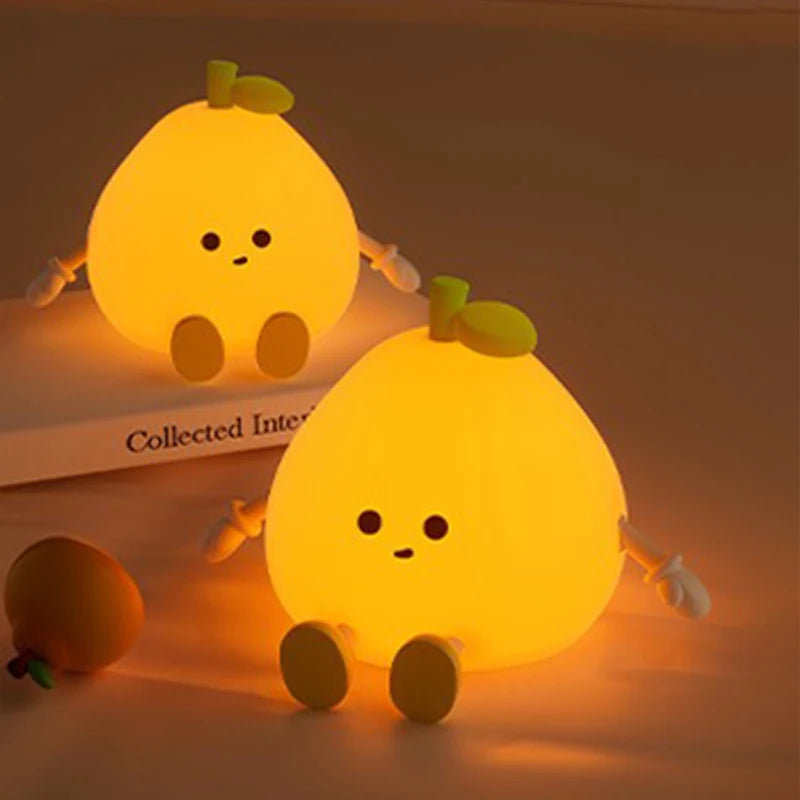 Two cute lemon-shaped kawaii night lights on a surface with a warm glow.