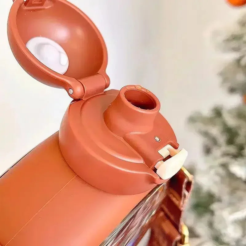 Close-up of a terracotta-colored kawaii water bottle with a white interior, possibly a kitchen appliance or decorative item.