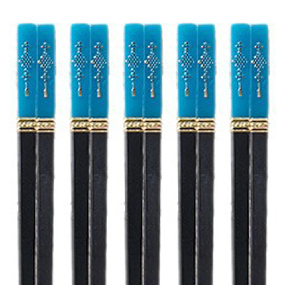Set of black kawaii chopsticks with blue handles featuring gold accents on a white background