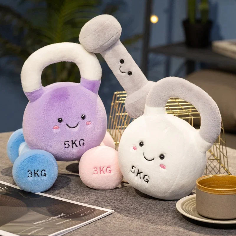 Set of kawaii plush toy dumbbells on a table with a blurred background