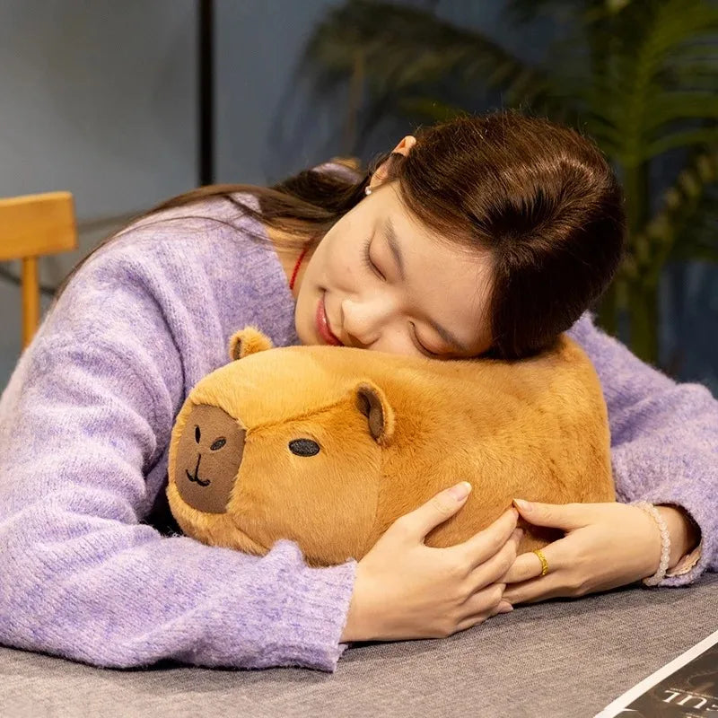 Person hugging a brown hippo-shaped kawaii pillow with a smiley face.