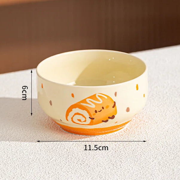 Ceramic kawaii bowl with cartoon design on a white surface, showing dimensions.