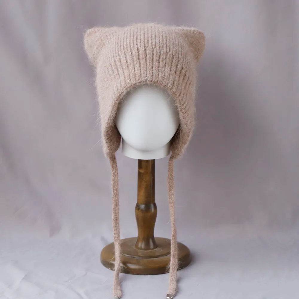 Beige knitted cat ear Kawaii hat on a mannequin head against a plain background