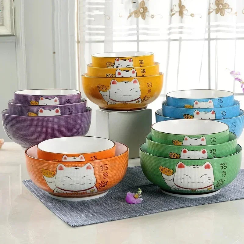 Set of colorful kawaii bowls with cat designs on a neutral background