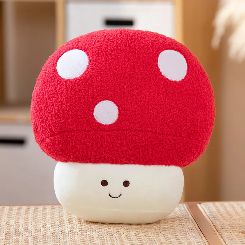 Cute mushroom-shaped kawaii plush toy with a red cap and white spots on a wooden surface.