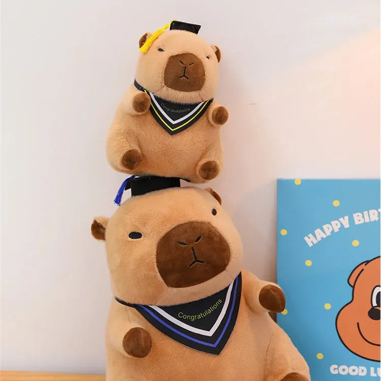 Two brown kawaii plush toys stacked on a wooden surface with a 'Happy Birthday' card in the background.