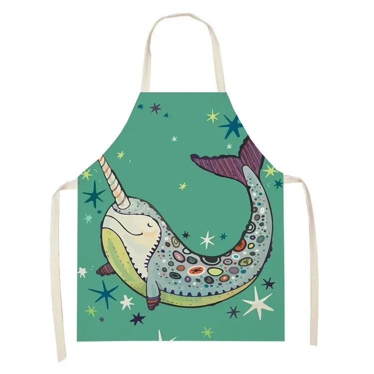Children's kawaii apron with a colorful narwhal design on a green background