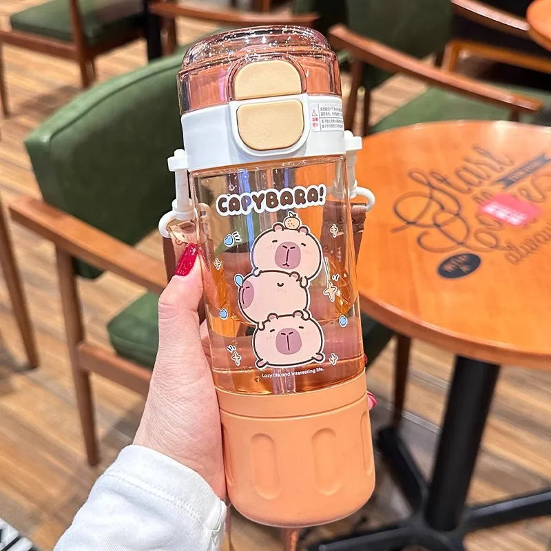 Capybara kawaii water bottle held in a hand with a blurred cafe background