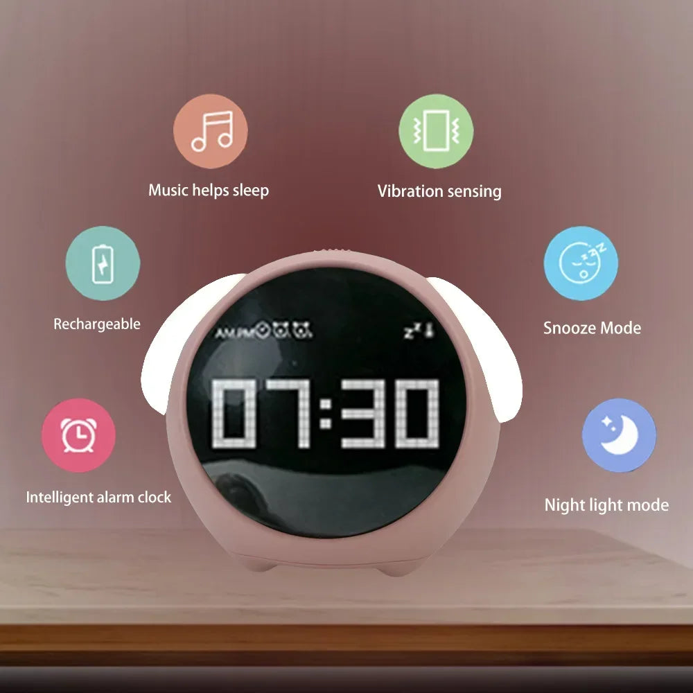 Pink kawaii alarm clock with features like music, vibration sensing, rechargeability, and night light mode displayed on a wooden surface.