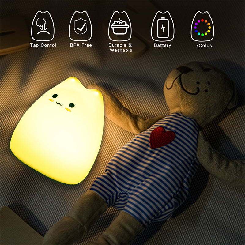 Light-up kawaii cat-shaped toy next to a plush teddy bear on a textured surface with feature icons above.