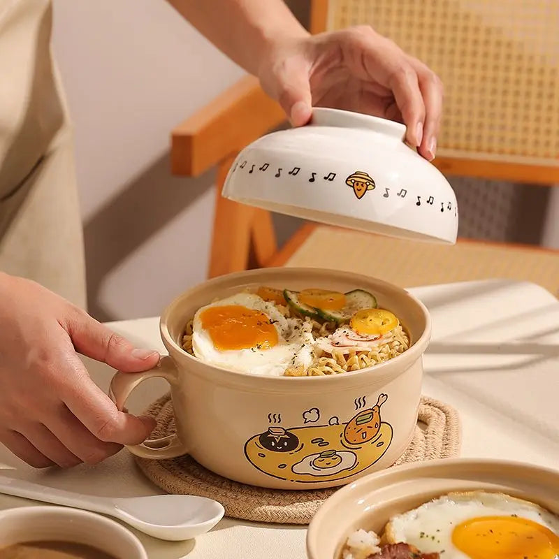 Someone opening up a kawaii ramen bowl with a lid, revealing ramen