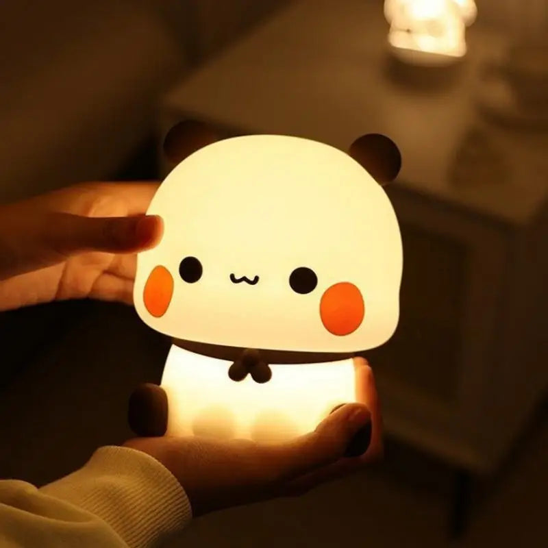 Cute panda-shaped kawaii night light held in a hand with a blurred background