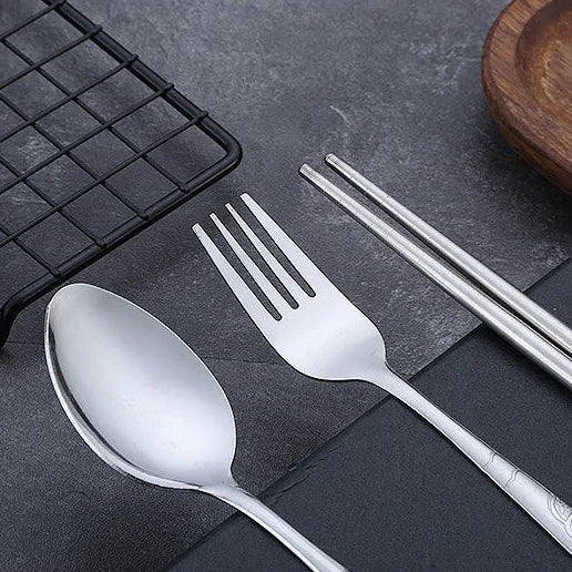 Set of silver kawaii utensils including spoon, fork, and chopsticks on a dark surface with text overlay.