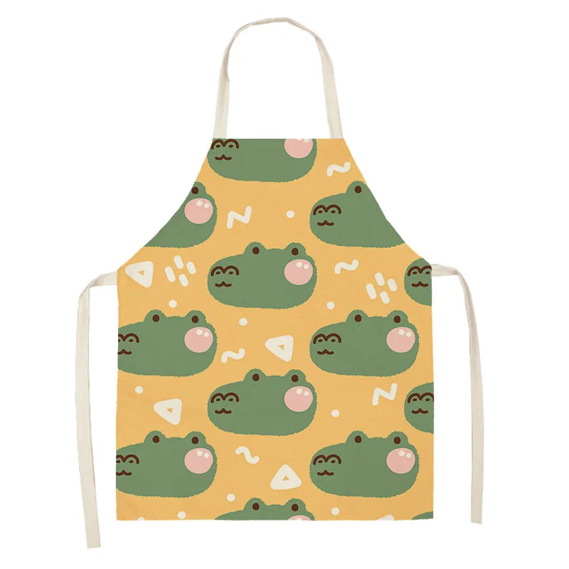 Children's kawaii apron with green frog pattern on a yellow background