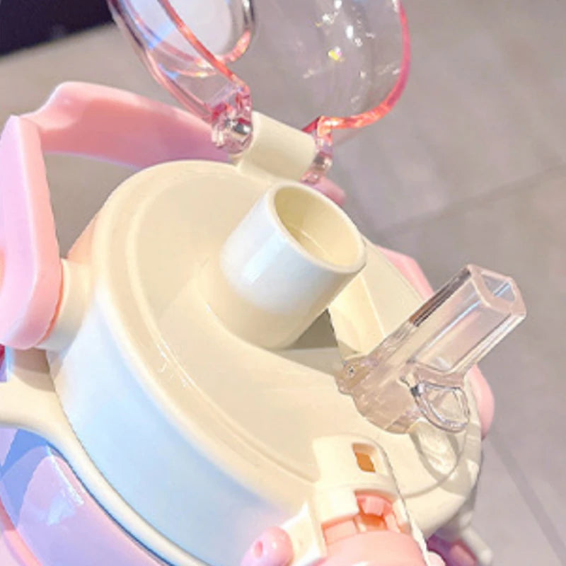 Close-up of a pink and beige kawaii bottle with a clear nozzle.