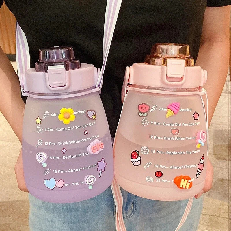 Two pink kawaii water bottles with time markers and cartoon designs held by a person.