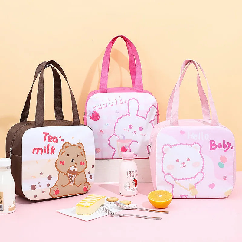 Three cartoon-themed kawaii lunch bags on a pink surface with a yellow background