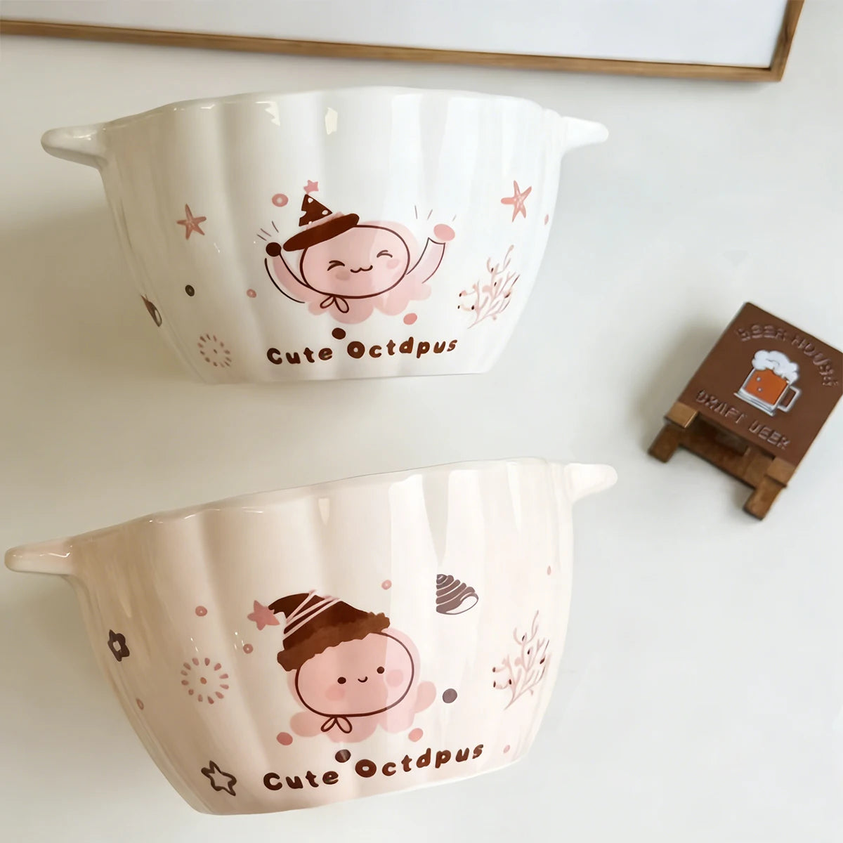 Two pumpkin shaped kawaii ramen bowls sitting on the table