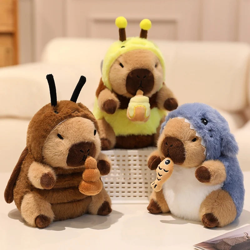 Three kawaii plush toys resembling animals in costumes on a light surface.