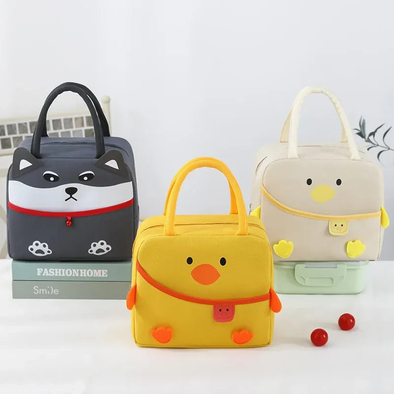 Three cartoon-style kawaii lunch bags in gray, yellow, and beige on a white background.