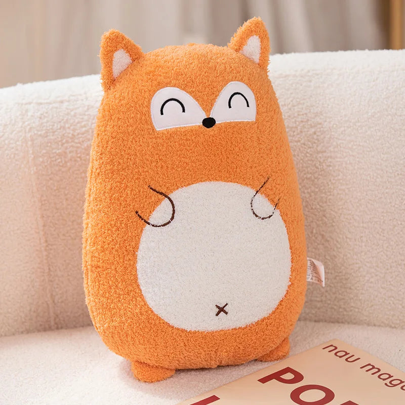 Kawaii plush fox pillow on a couch with a book underneath