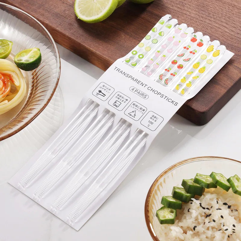 Set of kawaii chopsticks with packaging on a table with food items.