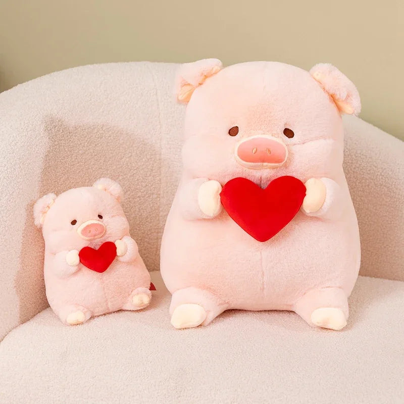 Two pink kawaii pig plushies with love hearts, sitting on a sofa