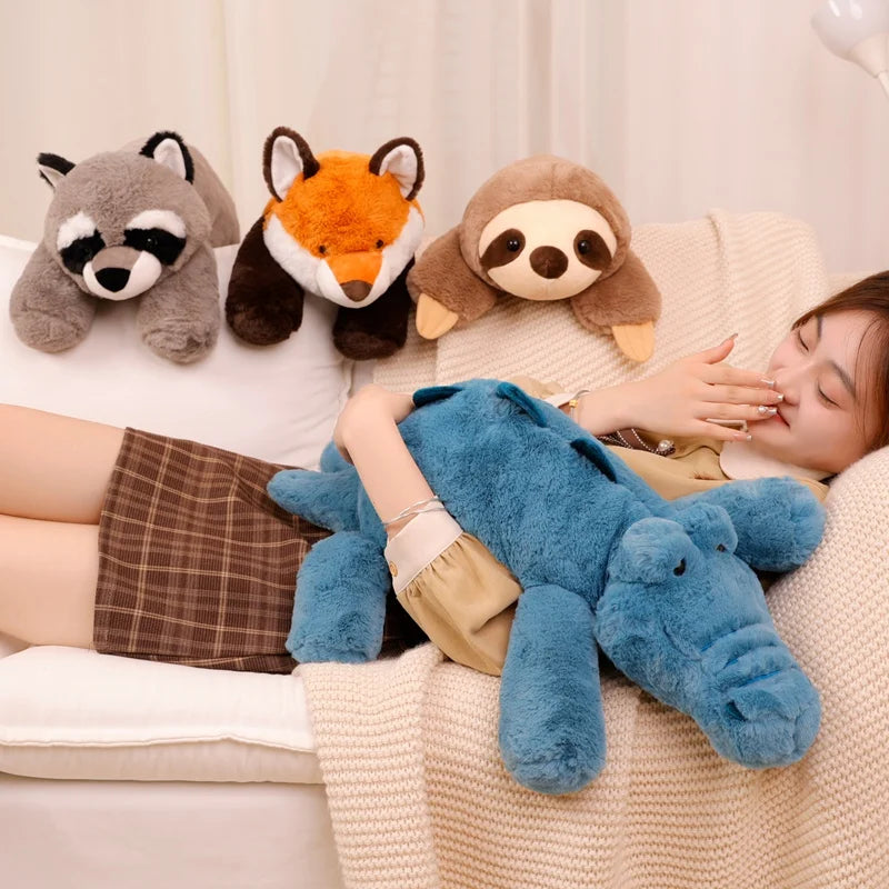Person lying on a couch with kawaii plush toys of a raccoon, fox, and sloth.