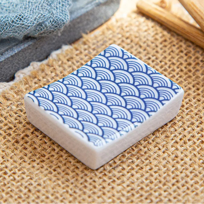 Rectangular kawaii chopstick holders with wave pattern on a textured surface