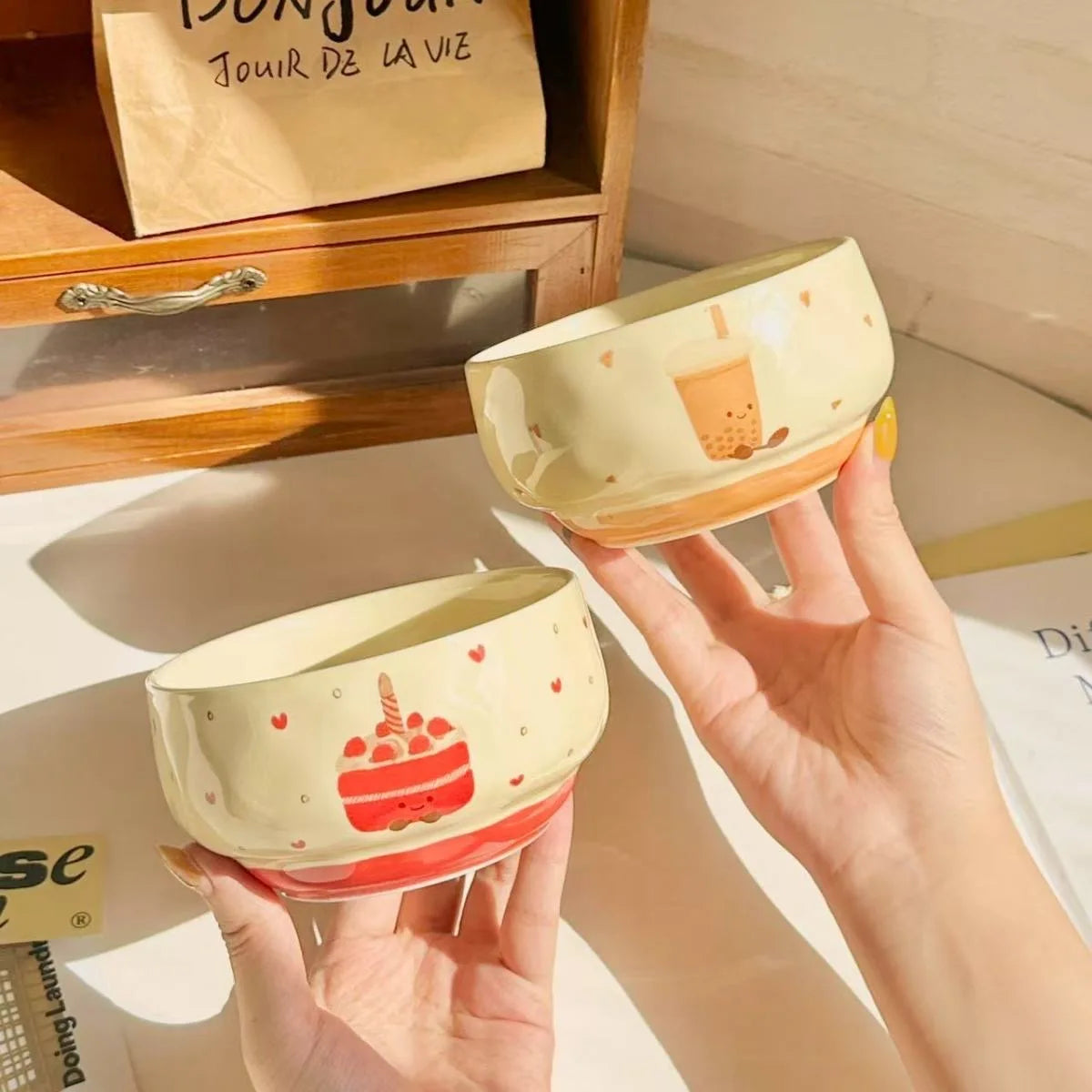 Two cartoon kawaii bowls being held by someone