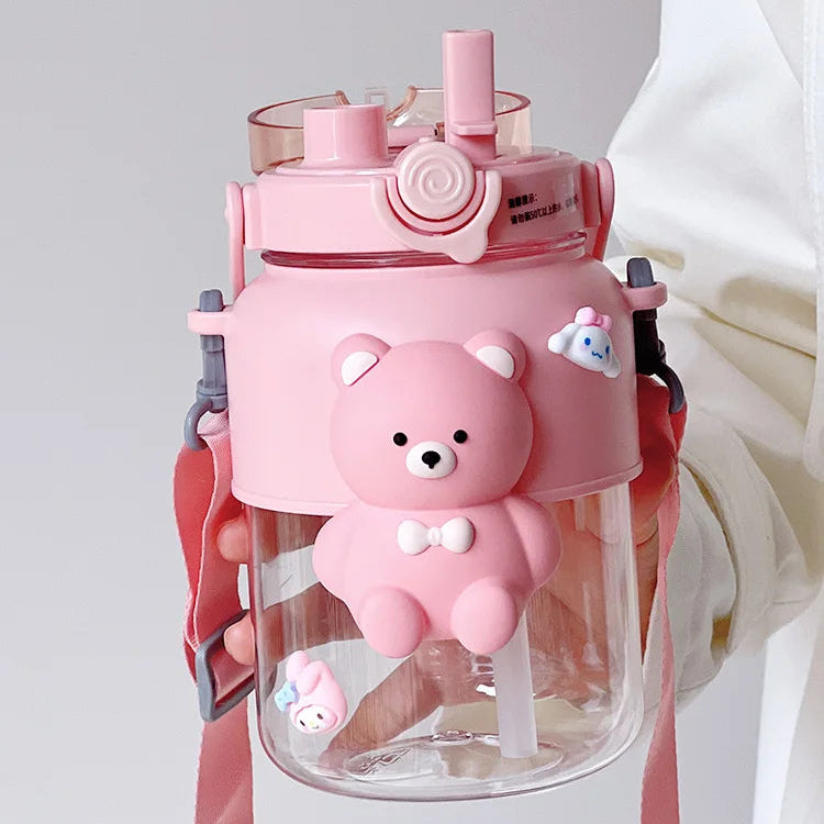 Pink bear-shaped kawaii water bottle with a clear body on a light gray background