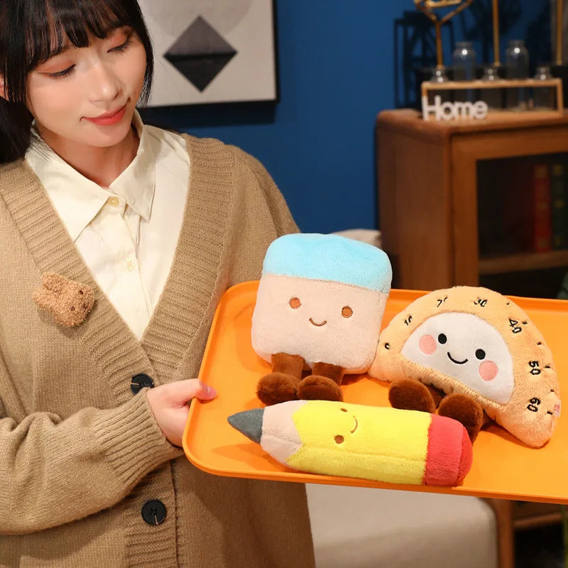 Person holding a tray with kawaii plush toys resembling a pencil, a character, and a cookie.