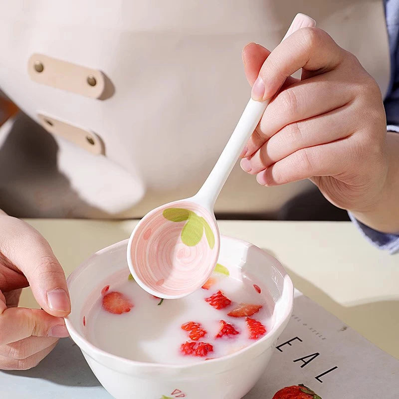 A person holding a strawberry designed kawaii spoon